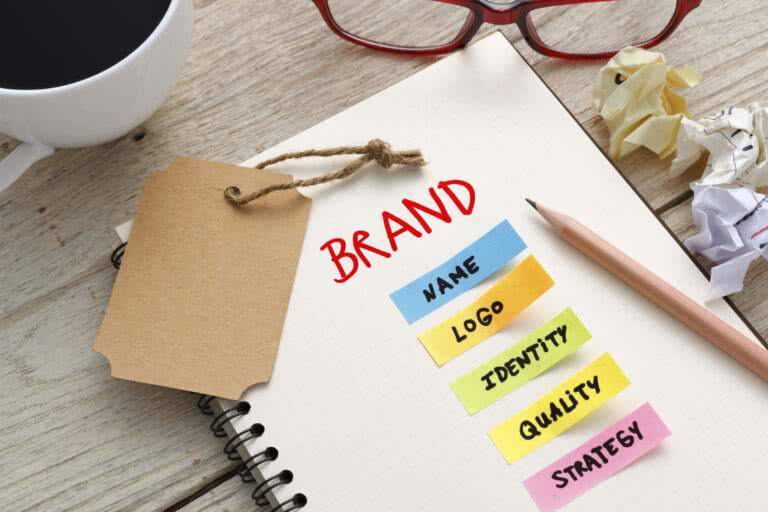 Brand marketing concept with notebook, brand tag and coffee cup on office desk